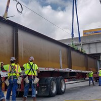 unloading a beam with a crane for bridge project